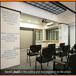 Backlit cement sheet Jaali in the ceiling and text engraved on MDF covering the pillars installed in an sports clinic copy